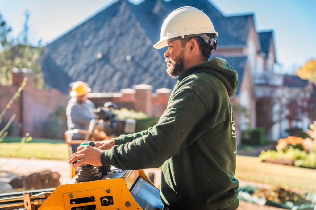 Salas team member operating stump grinder